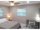 Bright bedroom with two windows, a built-in desk, and a comfortable bed at 2042 Craft Ln, Sarasota, FL 34239