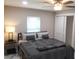 Comfortable bedroom featuring a queen-size bed, sleek nightstand, and large sliding-door closet at 2042 Craft Ln, Sarasota, FL 34239