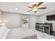 Bedroom featuring stylish marble floors, a ceiling fan, and an entertainment center with a cooler at 2042 Craft Ln, Sarasota, FL 34239