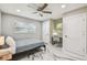 Inviting bedroom with a ceiling fan, desk, chair, and large windows offering ample natural light at 2042 Craft Ln, Sarasota, FL 34239