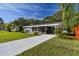 Charming single-story home with a well-maintained lawn and a covered carport offering shade and protection at 2042 Craft Ln, Sarasota, FL 34239