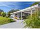 Contemporary home with a well-maintained lawn and manicured landscaping at 2042 Craft Ln, Sarasota, FL 34239
