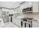 Updated kitchen with new stainless appliances, bright cabinetry, and stone countertops at 2042 Craft Ln, Sarasota, FL 34239