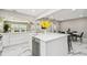 Bright, open kitchen with island seating, stone countertops, and stainless steel appliances at 2042 Craft Ln, Sarasota, FL 34239