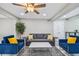 Cozy living room setup with a gray sofa, blue armchairs, and a neutral rug for a comfortable space at 2042 Craft Ln, Sarasota, FL 34239