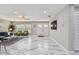 Spacious living room with marble floors, double front doors, and comfortable seating for a welcoming atmosphere at 2042 Craft Ln, Sarasota, FL 34239