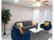 Cozy living room with stylish gray sofa, modern blue armchairs, and a white coffee table at 2042 Craft Ln, Sarasota, FL 34239