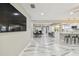 Open-concept living area with kitchen view, modern marble floors, and dining space for easy entertaining at 2042 Craft Ln, Sarasota, FL 34239