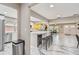 Open-concept living area with marble floors, a modern kitchen island, and a bar area at 2042 Craft Ln, Sarasota, FL 34239