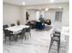 Spacious living room, kitchen, and dining area with marble floors and modern decor is open and inviting at 2042 Craft Ln, Sarasota, FL 34239