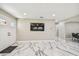 Bright living room with white marble floors, recessed lighting, and a wall-mounted television at 2042 Craft Ln, Sarasota, FL 34239