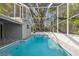 Enclosed pool with screened cage for outdoor enjoyment at 2042 Craft Ln, Sarasota, FL 34239