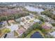 An aerial view shows the homes in this lakeside community, featuring lush trees and neighborhood ponds at 21215 Tyrell Way, Land O Lakes, FL 34638