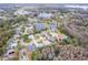 Aerial view of the neighborhood showcasing lush trees, community lakes, and manicured lawns at 21215 Tyrell Way, Land O Lakes, FL 34638