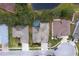 Aerial view showing the home with a screened-in pool, nestled amongst trees, and a quiet neighborhood at 21215 Tyrell Way, Land O Lakes, FL 34638