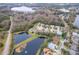 Aerial view of community lakes, roadways, and homes with tree coverage and landscaping at 21215 Tyrell Way, Land O Lakes, FL 34638