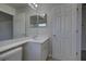 Bathroom with tile floor, single vanity, and updated lighting fixtures at 21215 Tyrell Way, Land O Lakes, FL 34638
