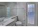 Bathroom featuring a vanity, toilet, and a glass paneled door allowing for natural light at 21215 Tyrell Way, Land O Lakes, FL 34638