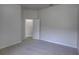 Cozy bedroom with neutral carpet, fresh paint, and a conveniently located ensuite bathroom at 21215 Tyrell Way, Land O Lakes, FL 34638