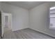 Bedroom with hardwood floors and neutral paint featuring a large window and closet at 21215 Tyrell Way, Land O Lakes, FL 34638