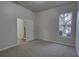 Bright bedroom with plush carpet, natural light, and access to the stairwell at 21215 Tyrell Way, Land O Lakes, FL 34638