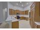 Well-lit kitchen featuring updated appliances, white countertops, and ample cabinet space at 21215 Tyrell Way, Land O Lakes, FL 34638
