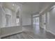 Large living room with wood-look floors and sliding doors to the lanai and pool area at 21215 Tyrell Way, Land O Lakes, FL 34638