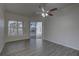 Spacious living room featuring wood-look floors, crown molding, and sliding glass doors to the pool at 21215 Tyrell Way, Land O Lakes, FL 34638