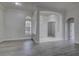 Inviting living room featuring wood-look floors, arched doorway, and lots of natural light at 21215 Tyrell Way, Land O Lakes, FL 34638
