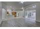 Open-concept living room with tile floors, large windows, and access to the screened-in patio at 21215 Tyrell Way, Land O Lakes, FL 34638