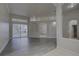 Open-concept living room with wood-look flooring and sliding glass doors to the backyard pool at 21215 Tyrell Way, Land O Lakes, FL 34638