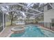 Beautiful view of lake beyond the pool, with spa and lanai at 21215 Tyrell Way, Land O Lakes, FL 34638