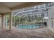Spacious pool and spa beneath a screen enclosure featuring scenic backyard views at 21215 Tyrell Way, Land O Lakes, FL 34638