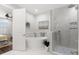 Bathroom featuring a soaking tub, a walk-in shower, and modern fixtures at 214 S Audubon Ave, Tampa, FL 33609