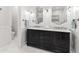 Bathroom featuring a double vanity with marble countertop, decorative mirrors, and sconce lighting at 214 S Audubon Ave, Tampa, FL 33609