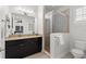 Modern bathroom features sleek vanity with granite countertop, glass shower, and toilet at 214 S Audubon Ave, Tampa, FL 33609