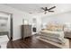 Spacious bedroom with hardwood floors features a dresser, ensuite bathroom, and ceiling fan at 214 S Audubon Ave, Tampa, FL 33609