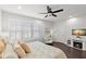 Bedroom features a ceiling fan, plantation shutters, and modern lighting at 214 S Audubon Ave, Tampa, FL 33609