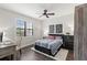 Bedroom featuring a ceiling fan, plantation shutters, and desk at 214 S Audubon Ave, Tampa, FL 33609