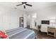 Cozy bedroom features a ceiling fan, closet, and an adjacent bathroom for added convenience at 214 S Audubon Ave, Tampa, FL 33609