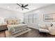 Bright bedroom featuring a ceiling fan, white walls, and window with plantation shutters at 214 S Audubon Ave, Tampa, FL 33609