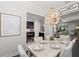 Elegant dining room with an ornate chandelier and open views into kitchen and living areas at 214 S Audubon Ave, Tampa, FL 33609