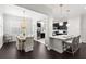 Bright dining room and adjacent kitchen with modern dark cabinets provides an elegant and functional space at 214 S Audubon Ave, Tampa, FL 33609