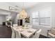 Bright dining room with elegant chandelier, plantation shutters, and dark wood floors at 214 S Audubon Ave, Tampa, FL 33609