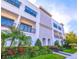 Contemporary townhome with balconies, tasteful landscaping, and a well-maintained lawn at 214 S Audubon Ave, Tampa, FL 33609