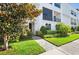Attractive condominium building with a manicured lawn and shrubbery at the entrance provides great curb appeal at 214 S Audubon Ave, Tampa, FL 33609