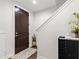 Inviting foyer featuring a dark wood door, staircase, and stylish decor offers a warm greeting at 214 S Audubon Ave, Tampa, FL 33609