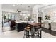 Open-concept kitchen featuring a breakfast bar with seating that connects to the living and dining areas at 214 S Audubon Ave, Tampa, FL 33609