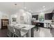 Stylish kitchen with stainless steel appliances, a white countertop island, and dark wood cabinets at 214 S Audubon Ave, Tampa, FL 33609