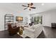 Cozy living room with hardwood floors, a ceiling fan, comfortable seating, and an entertainment center at 214 S Audubon Ave, Tampa, FL 33609